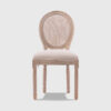 Light oak French cane back dining chair with beige upholstered seat, vintage-inspired accent chair for dining room