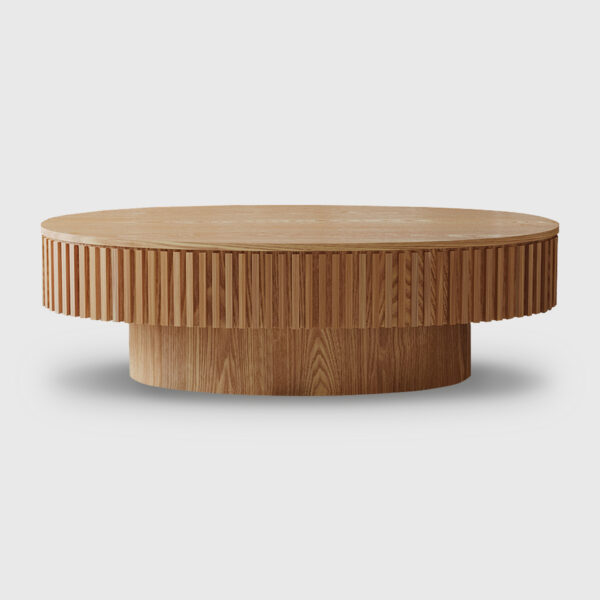 Modern oval storage coffee table with ribbed wood finish and lift top, placed in a cozy contemporary living room with boucle sofa