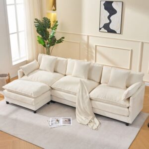 Beige modular sectional sofa with matching ottoman, plush upholstered living room sofa with throw pillows in a bright modern space