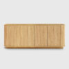 Light oak modern TV stand with double open storage cabinets, styled as a living room media console with decorative accessories and electronics storage